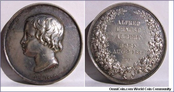 1850 UK Royal Family Children ALFRED ERNEST ALBERT Medal by L.C. Wyon. Silver: 32MM.
Obv: Portrait of Young Alfred Ernest Albert to right signed L.C.W. AUG: 1850.Rev: Wreath surround with legend ALFRED ERNEST ALBERT BORN AUG: 6, 1844.
