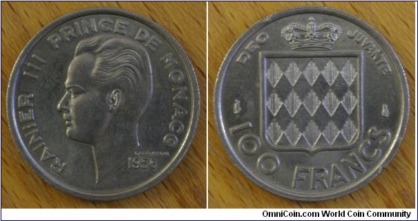Monaco | 
100 Francs, 1956 | 
24 mm, 6 gr. | 
Copper-nickel | 

Obverse: Prince Louis III facing left, date below | 
Lettering: RAINER III PRINCE DE MONACO 1956 | 

Reverse: National Coat of Arms, denomination below | 
Lettering: DEO JUVANTE 100 FRANCS |