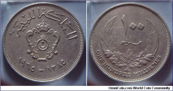 Kingdom of Libya | 
100 Millièmes, 1965 (1385) | 
30 mm, 11 gr. | 
Copper-nickel | 

Obverse: National Coat of Arms, date below | 
Lettering: المملكة الليبية ١٩٦٥–١٣٨٥ | 

Reverse: Denomination within wreath | 
Lettering: ١٠٠ مليم ONE HUNDRED MILLIÈMES |