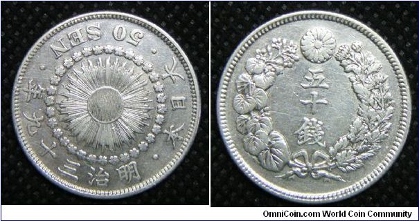 Mutsuhito (Meiji) Empire, 50 Cents, Year 39 (1906), Observe: Sunburst within cherry blossom circle with 3 legends seperated by dots around border. 10.1000 g, 0.8000 Silver, .2597 Oz. ASW. Mintage: 12,478,264 units. Very fine.