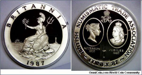 British Numismatic Trade Association, Britannia Silver Proof Medal, Coinex 1987. Obv: Britannia seated on a rock with trident. Rev: 2 portraits of Queen Victoria, in Young head and Jubilee Head versions, within two facing cartouches below a crowned VR cypher. 162.2700 g, .9250 Silver, 5.0000 Oz. ASW. 65mm. Mintage: 500 units. PROOF. Serial Number for this example: 031.