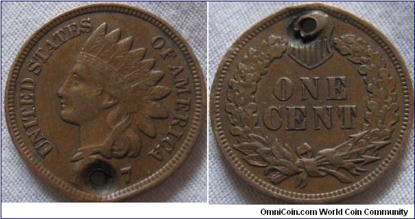 1907 1 cent, holed on the date but condition shows minimal wear so i'm guessing 1907