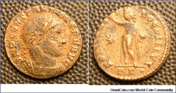 CONSTANTINE I
A.D. 307-337 	Æ Reduced Follis. Rev. SOLI INVICTO COMITI, Sol standing left raising right hand and holding globe, * in field, PT· in exergue, mint of Ticinum. 2.9gm 18mm RIC 16