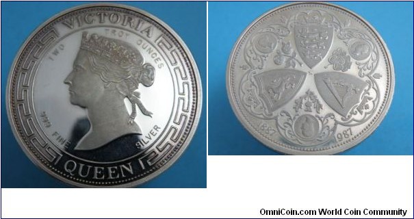 1987 UK 100th Anniversary of Queen Victorias Golden Jubilee Medal. Silver: 48MM./2 oz.
Obv: Portrait of Queen in Centre facing left with legend around reading QUEEN VICTORIA TWO TROY OUNCES.999 FINE SILVER. Rev: shows English, Scottish & Irish shield in centre with rose, shamrock & thistle between. Ornate boeard around.

