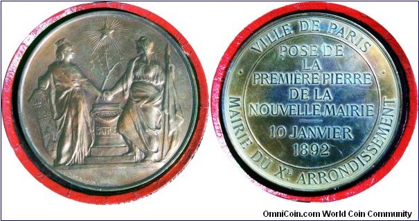 1879 Ville de Paris by Daniel Dupuis.  This is the first medal by Dupuis that uses allegorical figures to represent civic institutions, a theme that he would use throughout his career.  Here the figure of the Republic of France is holding a flag in her left hand while the right clasps the hand of the city of Paris.  The figure of the city is crowned with the city walls, a depiction dating back to Greek representations of Tyche.  The left hand of Paris rests on the coat of arms.    The handshake takes place over the altar of the “Patrie” or motherland.  A new plant rises from behind the altar towards a radiating star symbolizing the rebirth of France and Paris after the Franco-Prussian War.  This specific type was paired with multiple reverses.  It was the most popular of Dupuis' early types being reused continually until the creation of Marianne between 1889-1891.  The medal is 74mm Bronze 