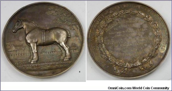 1888 UK Victorian Clydesdale Horse Society of Great Britain and Ireland Institutes 1877 Glasgow Show Best Brood Mare Medal strunk by Edward & Son . Silver 78MM./144 gms.
Obv: Clydesdale stallion stands left, in a paddock by stables. Rev:  Inscription 