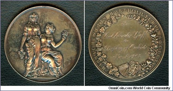1903 USA Massachusetts Horticultural Society Medal for Orchids By Francis Napoleon Mitchell. Gilted Silver 51MM./56.9 gm.
Obv: Roman Horticultural Goddesses Pomona standing besides seated Flora, holding grapes & flowers. Rev: Wreath around with United States & Massachusetts shields at the bottom, legend MASSACHUSETTS HORTICULTURAL SOCIETY. Details of award engraved in centre. 
