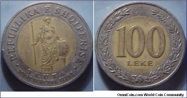 Albania | 
100 Lek, 2000 | 
24.75 mm, 6.7 gr. | Bi-metallic – Aluminium-bronze centre in Copper-nickel ring | 

Obverse: Teuta, Queen of Illyria, standing upright with spear, and date below | 
Lettering: • REPUBLIKA E SHQIPERISE • TEUTA MBRETERESHA ILIRE 2000 | 

Reverse: Denomintaion withing wreath | 
Lettering: 100 LEKE |
