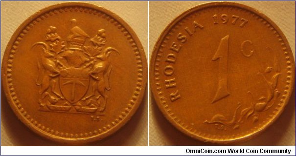 Rhodesia | 
1 Cent, 1977 | 
22.6 mm, 4 gr. | 
Bronze | 

Obverse: National Coat of Arms | 

Reverse: Denomination, date above | 
Lettering: RHODESIA 1977 1 C |