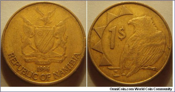 Namibia | 
1 Dollar, 1996 | 
22.6 mm, 5 gr. | 
Brass | 

Obverse: 1996 National Coat of Arms, date below | 
Lettering: REPUBLIC OF NAMIBIA | 

Reverse: Bateleur Eagle, partial sun design left, denomination in centre | 
Lettering: 1$ |