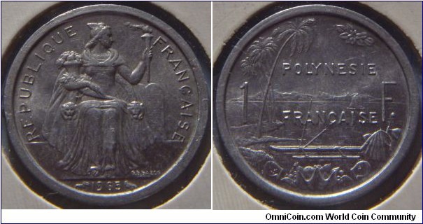 French Polynesia | 
1 Franc, 1965| 
23.5 mm, 1.4 gr. | 
Aluminium | 

Obverse: Seated Liberty on throne holding lit torch and assorted fruit facing right, date below | 
Lettering: REPUBLIQUE FRANÇAISE 1965 | 

Reverse: Palm trees on left, sailboat at sea min centre, mountains in distance. Boat with outrigger in foreground with assorted fruit in container, divide denomination| 
Lettering: POLYNESIE FRANÇAISE 1 F. |