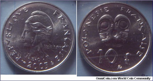 French Polynesia | 
10 Francs, 2003| 
24 mm, 6 gr. | 
Nickel | 

Obverse: Marianne facing left, date below | 
Lettering: REPUBLIQUE FRANÇAISE I•E • O•M• 2003 | 

Reverse: Two tikis back to back, denomination below| 
Lettering: POLYNESIE FRANÇAISE 10 f |