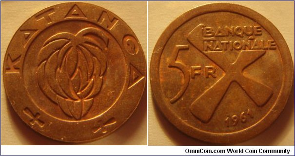Katanga |
5 Francs, 1961 |
26 mm, 6.54 gr. |
Bronze |

Obverse: Bunch of bananas |
Lettering: KATANGA |

Reverse: Denomination left, date below. The cross symbolizes iron bars |
Lettering: BANQUE NATIONALE 5 FR 1961 |