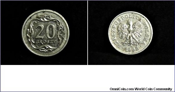 1992 20 GROSZY COIN

COUNTRY: Poland
PERIOD: Third Republic (1990-present)
COIN TYPE: circulation
DENOMINATION: 20 groszy
COMPOSITION: copper & nickel
MINT: Warsaw

OBVERSE: 1992 'RZECZPOSPOLITA POLKSA'; National Symbol of the Crowned White Eagle with wings spread, standing, head turned left (Designer: Stanislawa Watrobska-Frindt)

REVERSE: 20 GROSZY-denomination is within a square of leaves (Designer: Ewa Tyc-Karpinska)