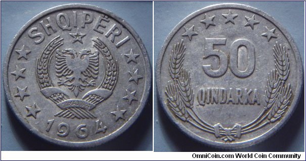 Albania | 
50 Qindarka, 1964 | 
24.49 mm, 2 gr | 
Aluminium | 

Obverse: National Coat of Arms, date below | 
Lettering: SHQIPËRI 1964 | 

Reverse: Denomination surrounded by ears of wheat and five stars | 
Lettering: 50 QINDARKA |