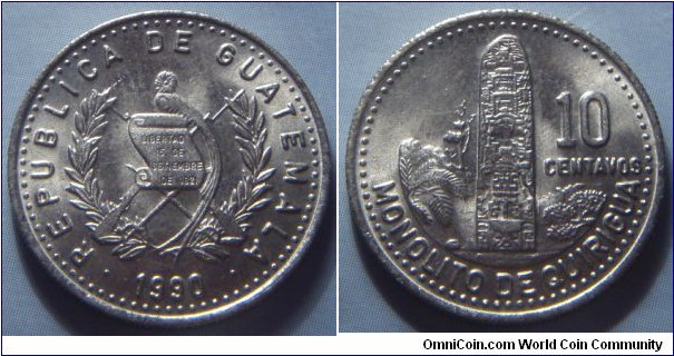 Guatemala | 
10 Centavos, 1990 | 
21 mm, 3.2 gr. | 
Copper-nickel-zinc | 

Obverse: National Coat of Arms, date below | 
Lettering: • REPUBLICA DE GUATEMALA • 1990 | 

Reverse: Monolith, denomination right | 
Lettering: MONOLITO DE QUIRIGUA 10 CENTAVOS |