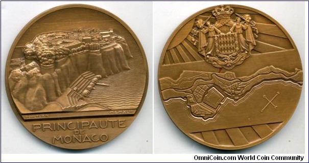 1943 Moraco Principaute De Monaco Medal by Pierre Turin. Bronze: 68MM.
Obv: Legend PRINCIPAUTE DE MONACO signed Pierre Turin dated MCMXLIII with a Panoroma of the cliff principality and distant palance. Rev: A map against the Sun rays, the Grimaldi arms above.

