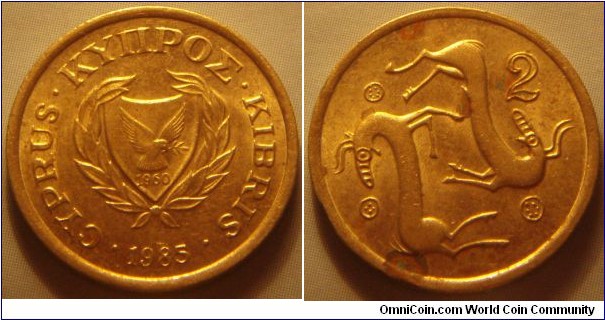 Cyprus |
2 Sent, 1985 | 
19 mm, 2.58 gr. | 
Nickel-brass | 

Obverse: National Coat of Arms with the independence year 1960, date below | 
Lettering: • CYPRUS • ΚΥΠΡΟΣ • KIBRIS • 1988| 

Reverse: A stylized animal couple with horns, denomination top right | 
Lettering: 2 |