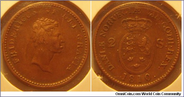 Denmark | 
2 Skilling, 1810 | 
21.69 mm, 5.5 gr. | 
Copper | 

Obverse: King Frederic VI facing right| 
Lettering: FRIDERICUS VI DEI GRATIA | 

Reverse: National Coat of Arms divides denomination, date below | 
Lettering: DANIÆ NOVEGIÆ VAN•GOTH•REX. 2 S. 1810. |