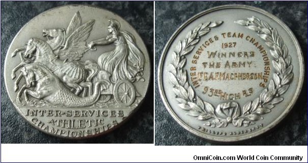 1927 UK Inter Services Athletic Championship Medal made by Phillips of Aldershot. 39MM
Obv: Roman Warrior riding chariot mounted with Air, Land & Sea Horses. Legend below exergual line INTER-SERVICES ATHLETIC CHAMPIONSHIPS. Rev: Awarded details with wreath surround. Signed PHILLIPS ALDERSHOT below.
