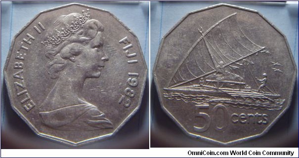 Fiji | 
50 Cents, 1982 | 
31.5 mm, 15.55 gr. | 
Copper-nickel | 

Obverse: Queen Elizabeth facing right, date right | 
Lettering: ELIZABETH II FIJI 1982 | 

Reverse: Sailing Canoe, denomination below | 
Lettering: 50 cents |