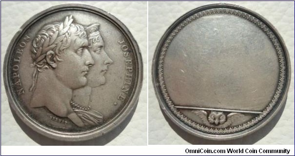 1804 France Napoleon & Josphine The Coronation Celebrated Presentation Medal by Brenet. Silver 35MM./21 gm.
Obv: Conjoined busts of Napoleon and Josephine to right. Rev: Blank (for inscription), owl's head below exergual line.
