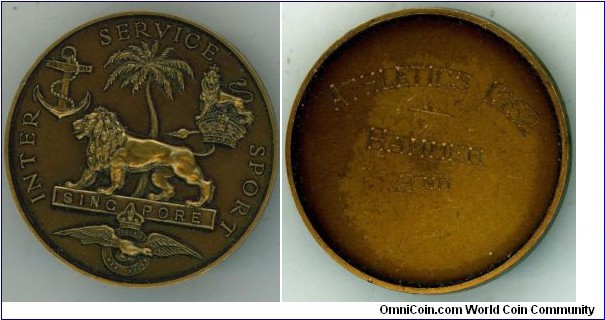 1952 UK Singapore Inter Service Sport Athletic Medal. Bronze: 38MM.
Obv: Lion represent Britian standing on banner SINGAPORE to left. Plam tree background with symbol of Royal Navy, Army & Air Forces. Legend INTER SERVICE SPORT. Rev: Inscription of awarded details ATHLETIC 1952 Hammer 2nd.  
