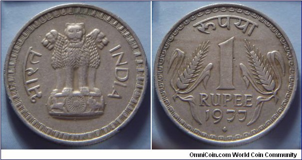 India | 
1 Rupee, 1977 | 
28 mm, 8 gr. | 
Copper-nickel | 

Obverse: Ashoka Lion Capitol | 
Lettering: भारत INDIA | 

Reverse: Denomination, date below | 
Lettering: रुपया 1 RUPEE 1977 |