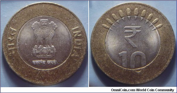 India | 
10 Rupees, 2011 | 
27 mm, 8 gr. | 
Bi-Metallic: Copper-nickel centre in Aluminium-bronze ring | 

Obverse: Ashoka Lion Capitol, date below | 
Lettering: भारत INDIA रूपये सत्यमेव जयते 2011 | 

Reverse: Wide rays, denomination below | 
Lettering: ₹ 10 |