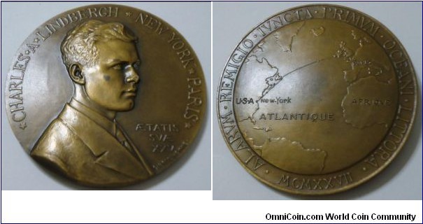 1927 France Charles Lindbergh Bronze Medal by Georges Prudhomme. Bronze: 67MM.
Obv: The Likeness of Lindbergh legend CHARLES A.LINDBERGH. NEW YORK PARIS AE.TATIS SVAE XXV. Signed G.PRVD HOMME. Rev: Map of the route, legend ALARVM REMIGIO IVNCTA PRIMVM OCEANI LITTORA MCMXXVII.
