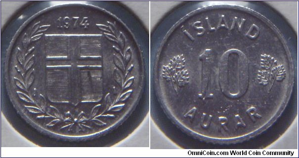 Iceland | 
10 Aurar, 1969 | 
15 mm, 1.6 gr. | 
Copper-nickel | 

Obverse: Flag of Iceland in shield within laurel wreath, date above |
Lettering: 1969 | 

Reverse: Denomination | 
Lettering: ÍSLAND 10 AURAR |