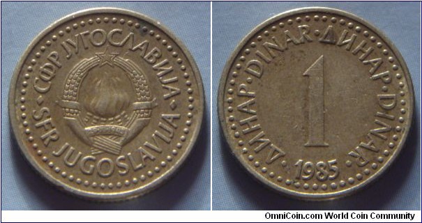 Yugoslavia | 
1 Hard Dinar, 1985 | 
20 mm, 3.6 gr. | 
Copper-brass | 

Obverse: National Coat of Arms | 
Lettering: •СФР JУГОСЛАВИJА•SFR JUGOSLAVIJA | 

Reverse: Denomination, date below | 
Lettering: •ДИНАР•DINAR•ДИНАР•DINAR• 1 1985 |