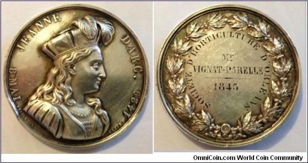 1845 France Jeanne D'Arc Horticultural Society of New Orleans Medal by Charles Pensee/Caque F. Silver: 45MM
Obv: Bust of Jeanne D'Arc to right. Legend JEANNE D'ARC 8 MAI, 1429. Signed PENSEE IN/CAQUE F.  Rev: Awarded by Horticultural Society of New Orleans to Vignat Parelle in 1845.
