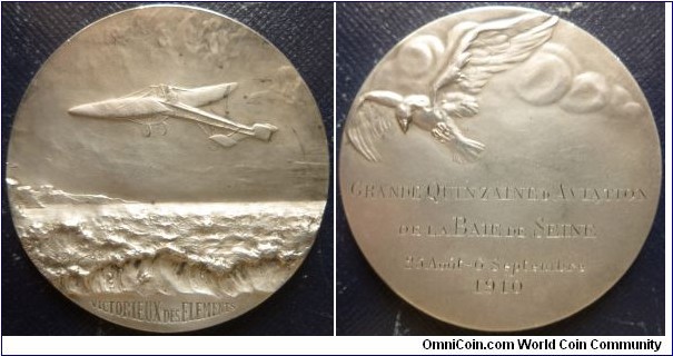 1910 France Victorieux Des Elements Medal by Charles Jean Cleophas Desvergnes (1860-1929). Silver: 49MM./52 gms.
Obv: Old airplain flying over rough sea towards inland destination. Exerque VICTORIEUX DES ELEMENTS. Rev: Flying Eagle over the clouds. Inscribed in 4 lines GRANDE QUINZAINED AVIATION DE LA BATE DE SEINE 25  AOUT - 6 SEPTEMBRE 1910.
