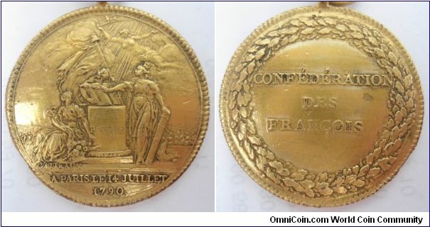 1790 French Revolution for the Confederation of the French Medal by Gatteaux. Gilt Bronze: 33MM.
Obv: Freedom is surmounted by a cap flag, on which there are two clasped hands as a sign of union also supports the book of the Constitution placed on an alter with inscribe 'A LA PATRIE'. France, crowned with lilies planted coat and holding a beam laid hands on the book to swear to uphold the Constitution. Public Felicity, holding cornucopia and caduceus, sits at the foot of the alter and reflects the joy he felt at such a beautiful moment. Truth hovers in the air, dispets the darkness of error and directs the light to the book of Constitution. Abov, a portion of the zodiac, Leo in which the sun during the month of July. Federated around the alter and the Military Academy on left, inscribed 'A PARIS LE 14 JUILLET, 1790',  signed GATTEAUX (for Nicolas-Marie Gatteaux, 1751-1832). Rev: Inscribed 'CONFEDERATION DES FRANCOIS' within a circular wreath of Oak and Laurel. 
