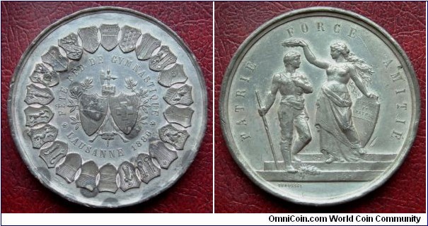1880 Swiss Lucerne Federal Gymnastic Fete Medal by Durussel. White Metal: 47MM
Obv: Shield of Swiss & Lausanne surround by other 22 Canton shields. Legend FETE FED DE GYMNASTIC LAUSANNE 1880. Rev: Female figure crowning warrior represent Lausanne. Legend PATRIE FORCE AMITIE. Signed DURUSSEL.
