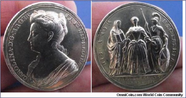 1727 UK Queen Caroline Coronation Medal by John Croker. Silver: 35.2MM.
Obv: Bust of Queen Caroline to left. Legend CAROLINA.D:G. MAG. Rev: Legend HIC'AMOR'HAEC.PATRIA. Exergue CORN.XL.OCTOB MDCCXXVII.

