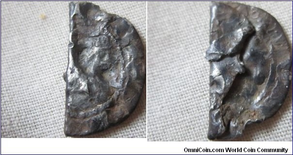 unidentified hammered penny, folded in middle and battered leaving few details.