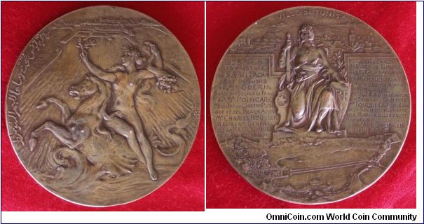 1893 France The opening of the Port of Tunis in the presence of SA Ali Pasha Bey of Tunis in 1893 Medal by Louis Bottee. Bronze: 68MM./147 gms.
Obv: Personification of the Mediterranean marine riding a horse in the waves. Her right hand holds an olive branch, symbol of peace, and in the left a cornucopia. Background is the new port of Tunis.Signed louis Bottee Rev:  Female seated on thorne with sword & shield above map & City of Tunis. Legend decribed opening of Port.
