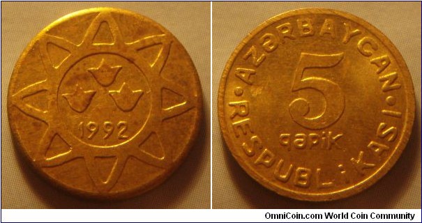 Azerbaijan | 
5 Qəpik, 1992 | 
17 mm, 2.4 gr. | 
Brass | 

Obverse: Three symbols inside star, date below | 
Lettering: 1992 | 

Reverse: Denomination | 
Lettering: • AZƏRBAYCAN • RESPUBLİKASI 5 qəpik |