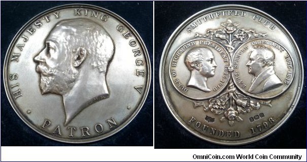 1932 UK George V, Smithfield Club founded 1798 Patron's Medal made by Mappin & Webb with Hallmarked for Birmingham for 1932.  Silver: 55MM./76.4 gms.
Obv: The portrait of HIS MAJESTY KING GEORGE V. PATRON. Rev: Dipcting the profile of Presidents Earl Spencer 1825-1845 & The Duke of Richmond 1841-1860. With punch of roses and ribbons in centre. Legend SMITHFIELD CLUB FOUNDED 1798.  Hallmarks: MN&WB, Date Letter H 1932, Lion .925 Sterling Silver, Anchor Birmingham.
