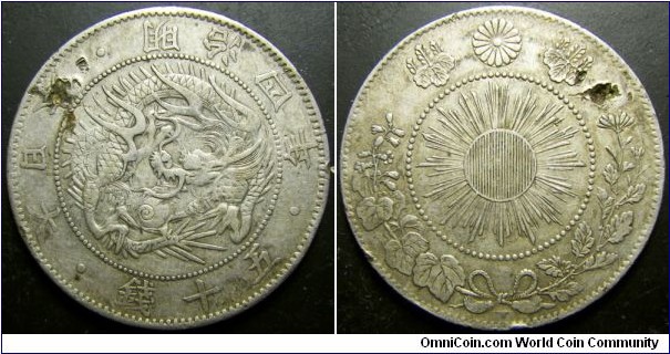 Japan 1871 50 sen. A reasonable condition coin except for the attempted hole damage. Weight: 12.37g. 