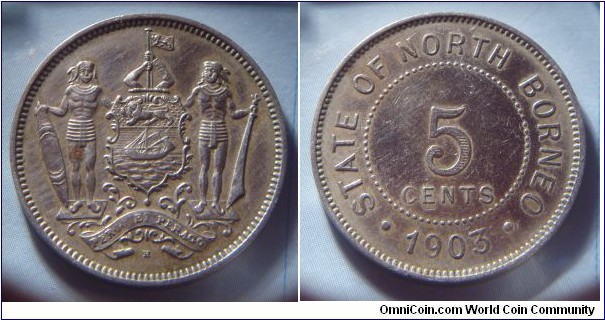 North Borneo | 
5 Cents, 1903 | 
28.1 mm, 7.3 gr. | 
Copper-nickel | 

Obverse: Coat of Arms with supporters | 

Reverse: Denomination, date below | 
Lettering: • STATE OF NORTH BORNEO • 1903 |