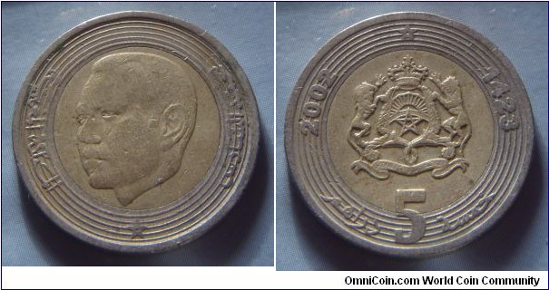 Morocco | 
5 Dirhams, 2002 (1423) | 
25 mm, 7.5 gr. | 
Bi-metallic: Brass centre in Copper-nickel ring | 

Obverse: King Hassan VI facing left | 
Lettering: محمد السادس المملكة المغربية |

Reverse: National Coat of Arms, date left and right, denomination below | 
Lettering: 2002 1423 خمسة 5 دراهم |