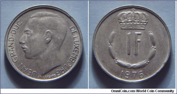 Luxembourg | 
1 Franc, 1976 | 
21 mm, 4 gr. | 
Copper-nickel | 

Obverse: Adolphe, Grand Duke of Luxembourg facing right | 
Lettering: JEAN GRAND-DUC DE LUXEMBOURG |

Reverse: Crowned  upturned horseshoe shaped of six flower buds surrounds denomination, date below | 
Lettering: 1F 1976 |