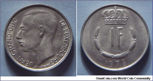 Luxembourg | 
1 Franc, 1978 | 
21 mm, 4 gr. | 
Copper-nickel | 

Obverse: Adolphe, Grand Duke of Luxembourg facing right | 
Lettering: JEAN GRAND-DUC DE LUXEMBOURG |

Reverse: Crowned  upturned horseshoe shaped of six flower buds surrounds denomination, date below | 
Lettering: 1F 1978 |