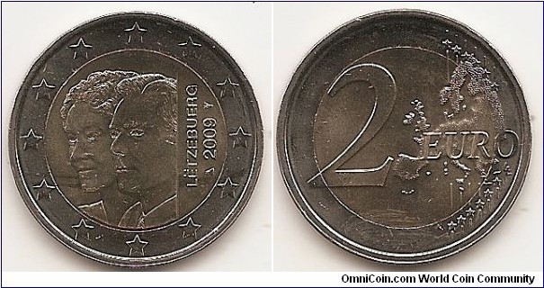 2 Euro
KM#106
8.5000 g., Bi-Metallic Nickel-Brass center in Copper-Nickel ring, 25.75 mm. Subject: 90th Anniversary of Grand Duchess Charlotte's Accession to the Throne. Obv: The coin shows the effigy of Grand Duke Henri on the left hand side of its inner part, superimposed on the effigy of the Grand Duchess Charlotte, both looking to the left. The vertically aligned text LËTZEBUERG and the year mark, flanked by the mint master's mark and the mint mark, appear on the right hand side of the inner part of the coin. The twelve stars of the European Union surround the design on the outer ring of the coin. Rev: 2 on the left-hand side, six straight lines run vertically between the lower and upper right-hand side of the face, 12 stars are superimposed on these lines, one just before the two ends of each line, superimposed on the mid - and upper section of these lines; the European continent ( extended ) is represented on the right-hand side of the face; the right-hand part of the representation is superimposed on the mid-section of the lines; the word ‘EURO’ is superimposed horizontally across the middle of the right-hand side of the face. Under the ‘O’ of EURO, the initials ‘LL’ of the engraver appear near the right-hand edge of the coin. Edge: Reeded with combination of the number 2 and ** repeated six times. Obv. designer: Alain Hoffmann Rev. designer: Luc Luycx