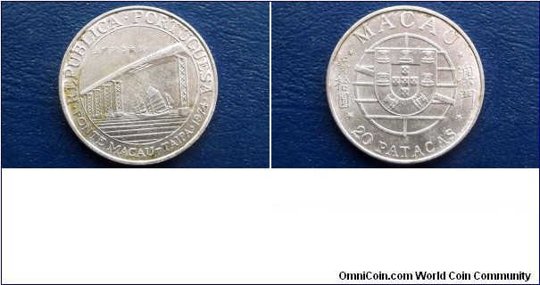 Macao 20 Patacas KM# 8     1974
1974
1974 Macao 20 Patacas obverse

	
	1974 Macao 20 Patacas reverse

This Photo is for Reference !!!
  
Specifications

Composition: Silver

Fineness: 0.6500

Weight: 18.0000g

ASW: 0.3761oz

Diameter: 35mm
Design

Obverse: Macau shield within globe

Reverse: Junk (ship) passing under Taipa bridge within circle