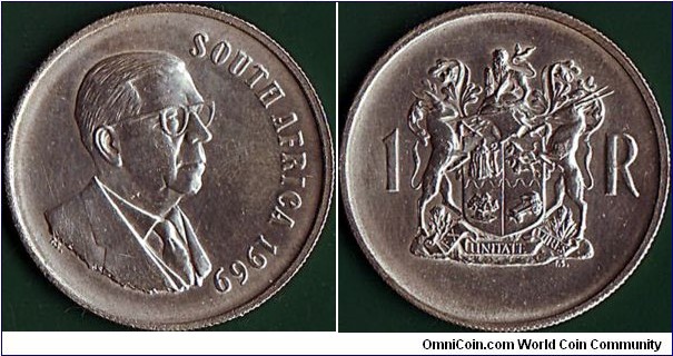 South Africa 1969 1 Rand.

English inscription.

T.E. Donges.

Off-centre in the 1 O'Clock position.