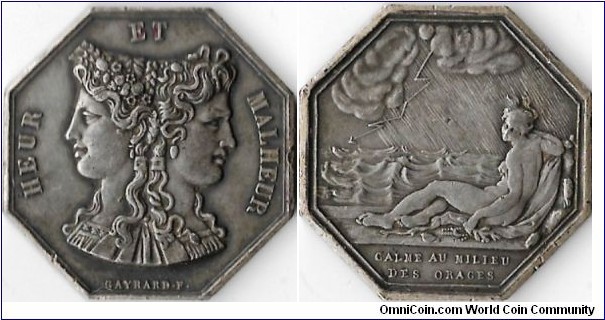 silver gaming token. Obverse: Good luck / bad luck janiform head. Reverse: calm in the middle of storms.
